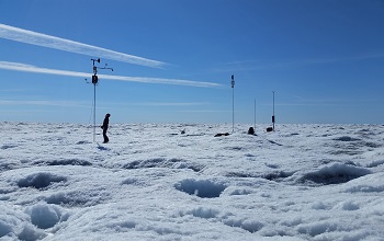 Man testing instrument over icy landscape
